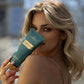 Close-up of woman displaying 7suns Pure Charm Gelee Accelerator tanning product