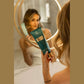 Woman holding 7suns Pure Charm Gelee Accelerator solarium tanning gel near mirror