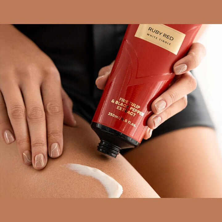 Applying white Ruby Red tingle cream to thigh for intense warming tan acceleration