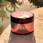 Soleo Collagen Tanning Butter Accelerator on wet stone surface with water droplets