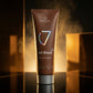 7suns Jet Black after tan lotion tube with silver cap on reflective surface