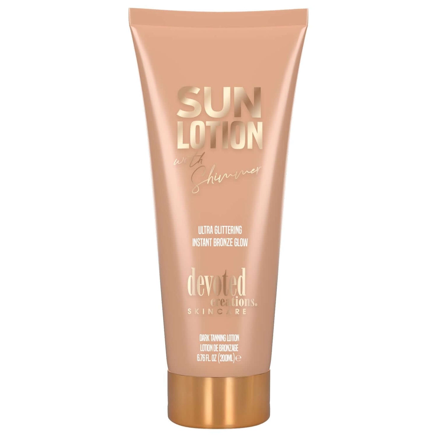 Peach Devoted Creations sun lotion tube with gold cap and glittering glow