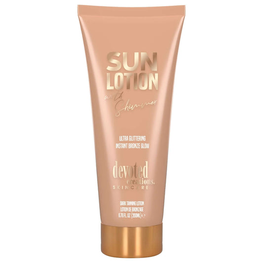 Peach Devoted Creations sun lotion tube with gold cap and glittering glow