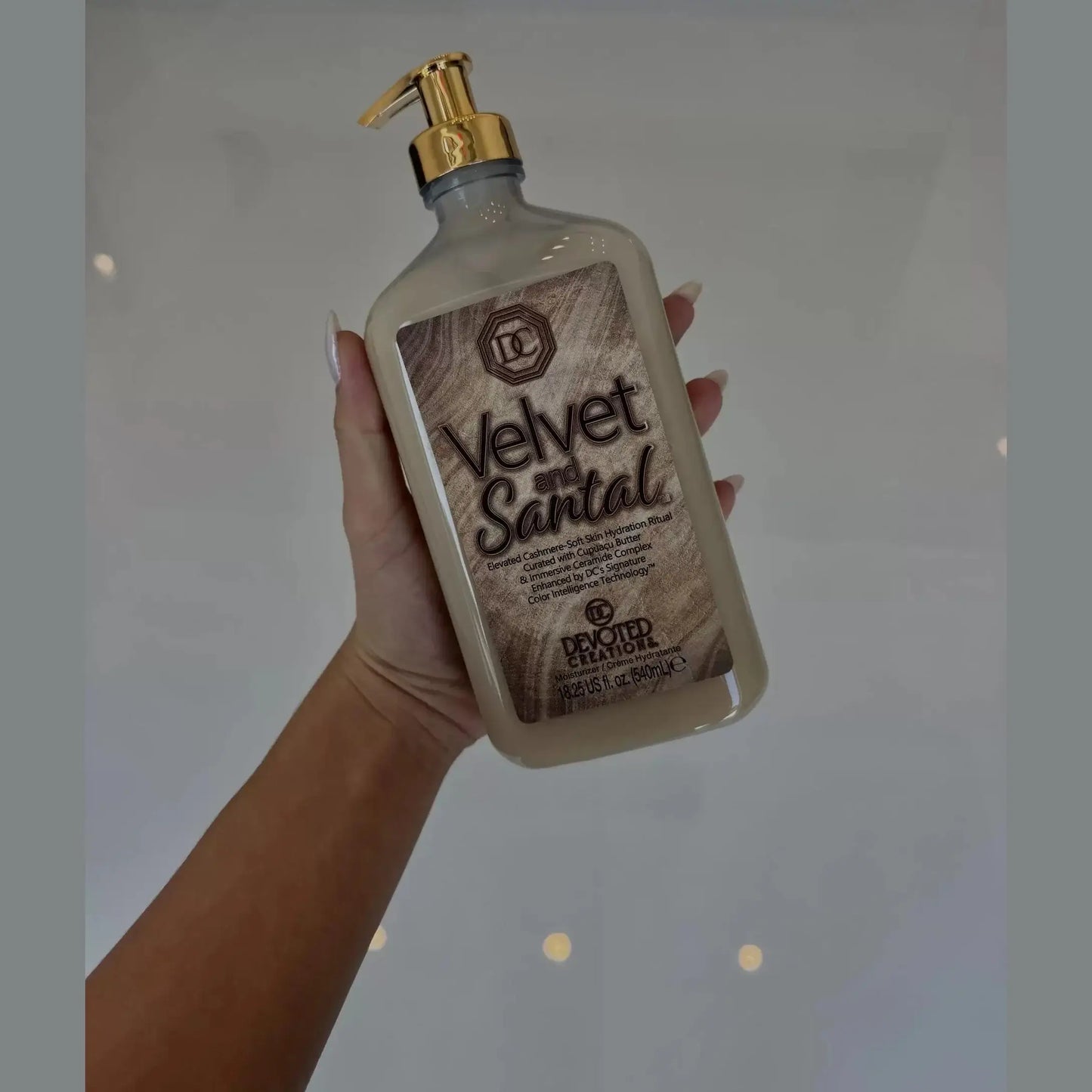 Devoted Creations Velvet and Santal body lotion in frosted beige bottle with gold pump