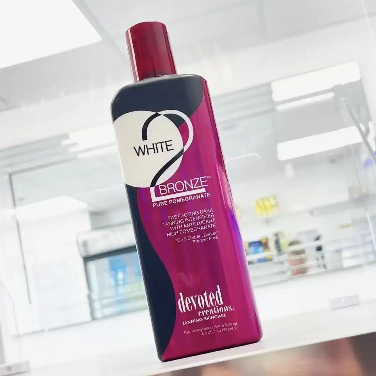 Devoted Creations White 2 Bronze tanning lotion held in salon setting