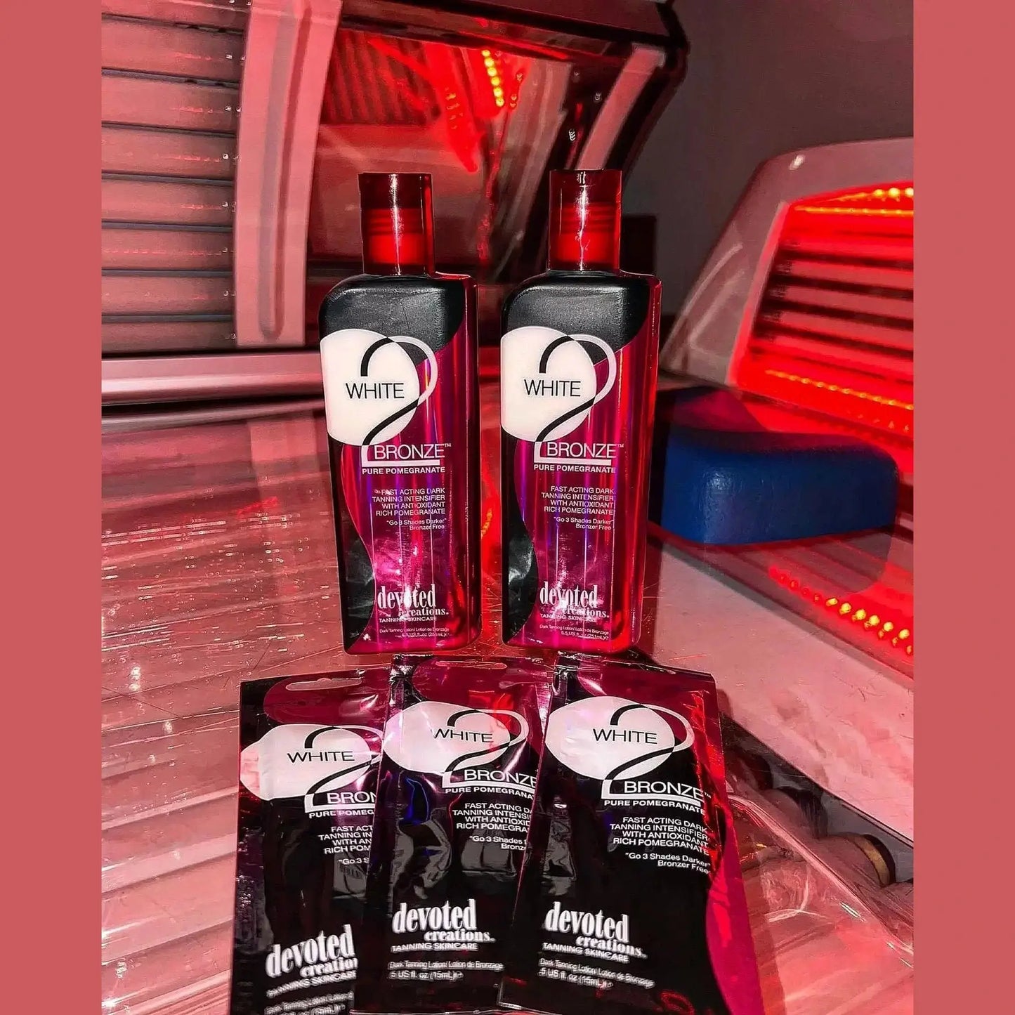 Devoted Creations White 2 Bronze tanning intensifier bottles and samples in tanning bed