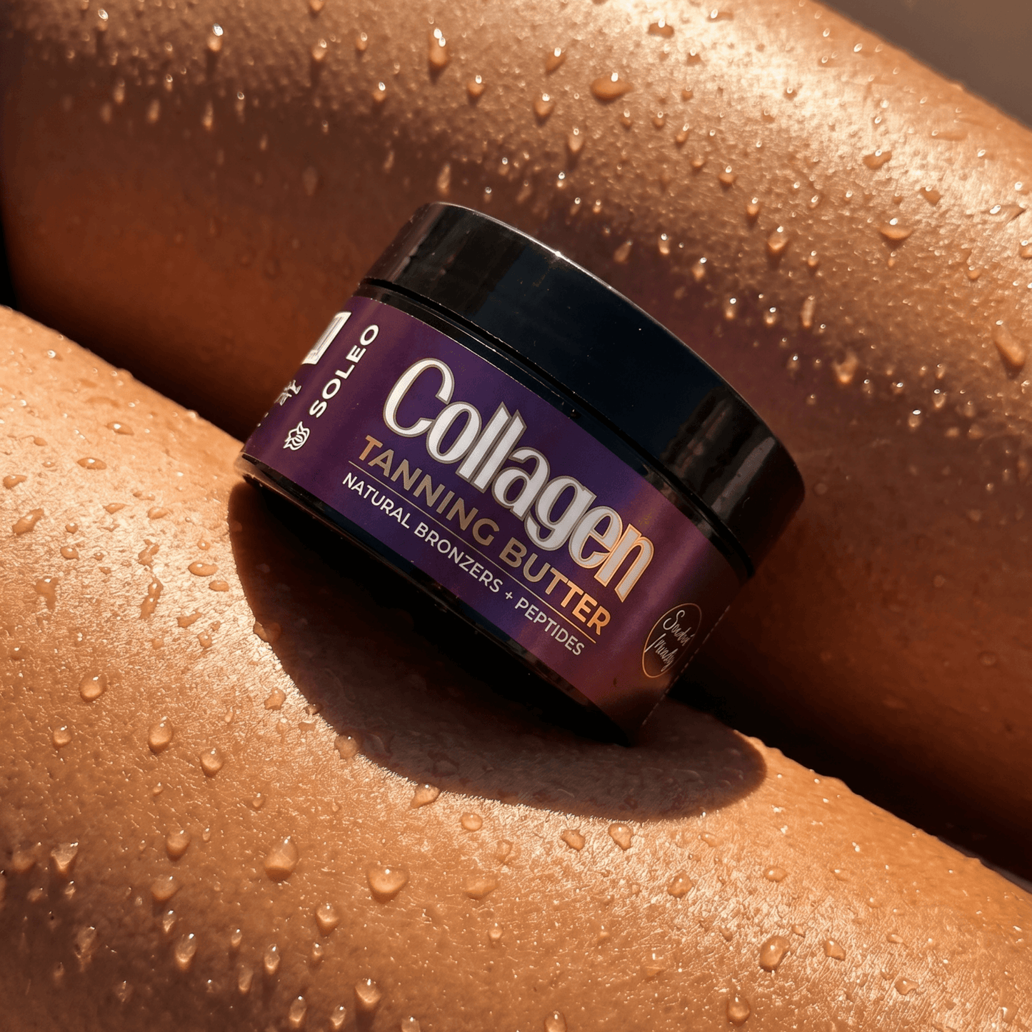 Close-up of Soleo tanning butter jar resting on dewy sun-kissed skin