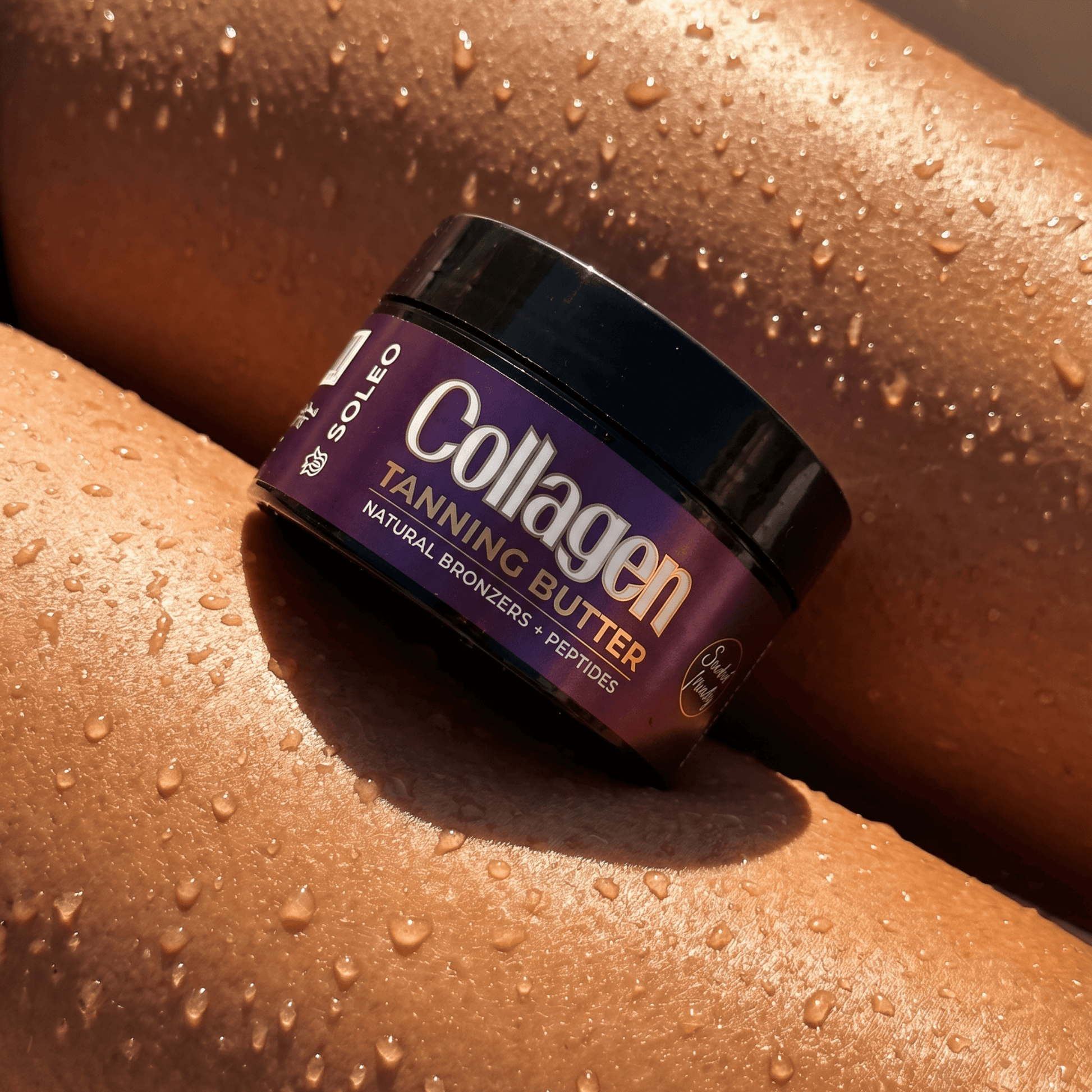 Close-up of Soleo tanning butter jar resting on dewy sun-kissed skin