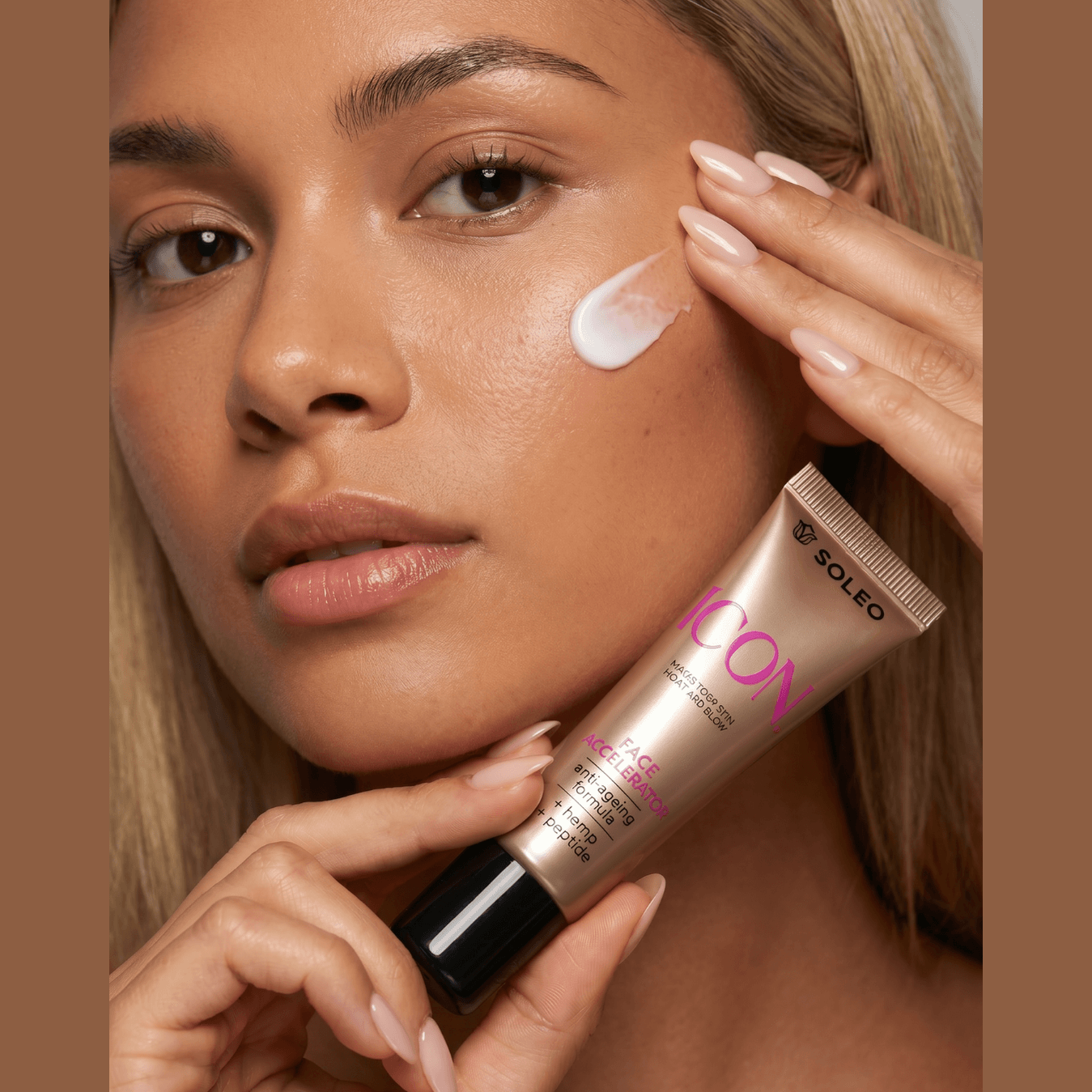 Close-up of woman applying Soleo Icon Face Accelerator cream, anti-ageing formula with hemp and peptides