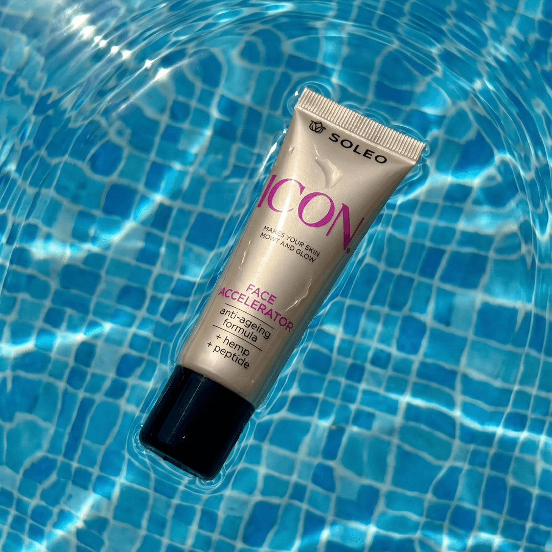 Soleo Icon Face Accelerator tube floating in blue pool water, gold packaging for facial tanning